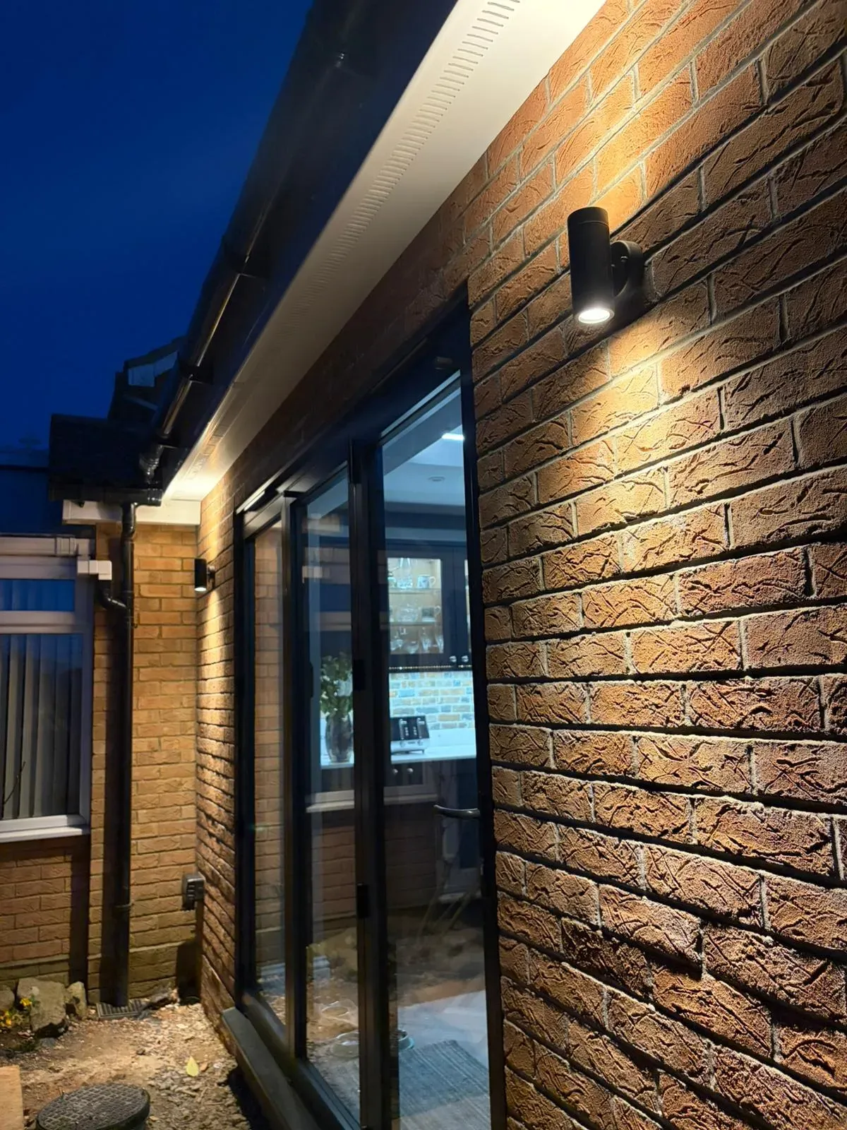 Professional outdoor wall light installation on a brick house in Felixstowe by NICEIC approved electricians