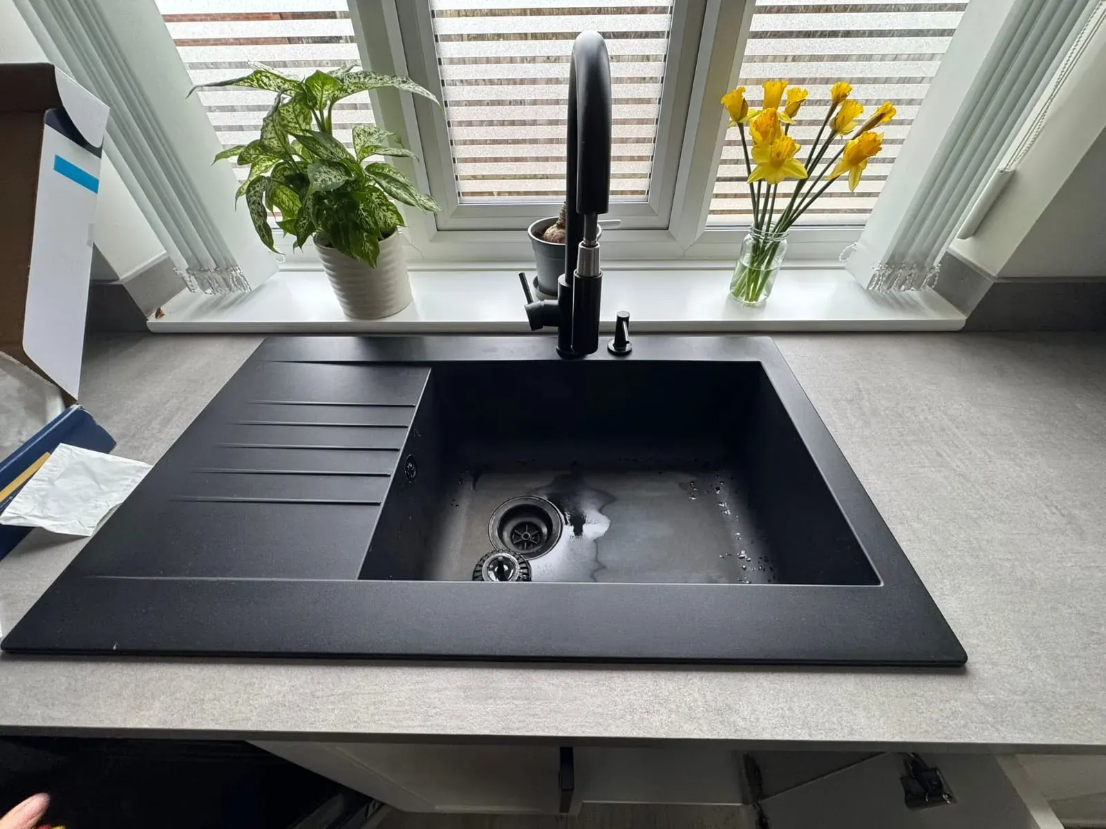 Modern black kitchen sink and tap installation by FLEX PROPERTY SERVICES in a Suffolk home.